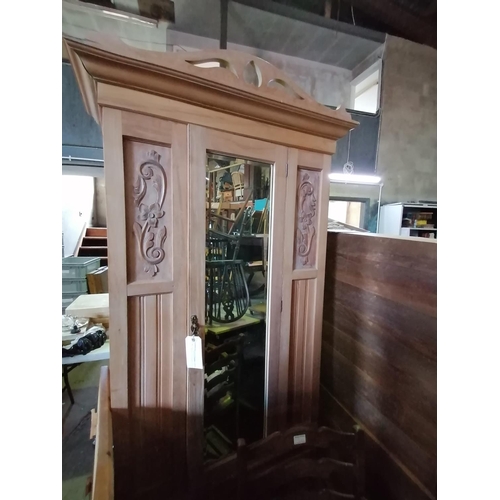 44 - A mirror-fronted pine wardrobe with decorative carved panels to front and brass door fitting H198 W9... 