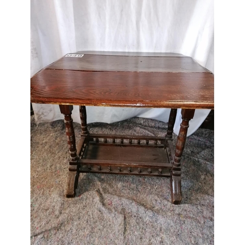 49 - A small Edwardian dropleaf table with balustraded lower tier on bracket feet; ht 59cm