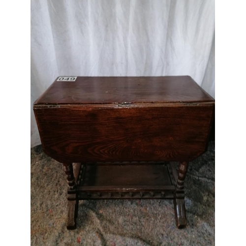 49 - A small Edwardian dropleaf table with balustraded lower tier on bracket feet; ht 59cm