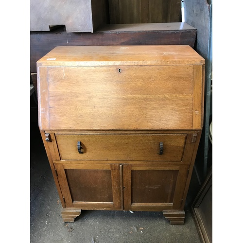 57 - An early 20C light oak fall front bureau with stationery compartments and working key H103 W76 D44 c... 