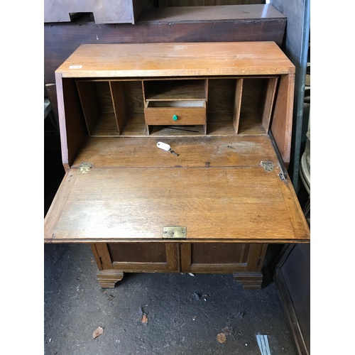 57 - An early 20C light oak fall front bureau with stationery compartments and working key H103 W76 D44 c... 