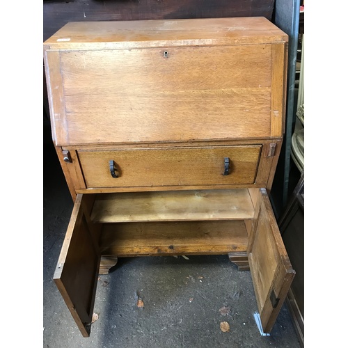 57 - An early 20C light oak fall front bureau with stationery compartments and working key H103 W76 D44 c... 