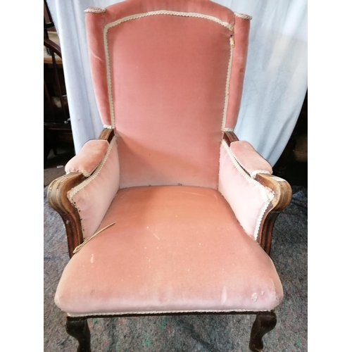 61 - A 19C high backed armchair, upholstered in salmon pink Draylon with braid piping, cabriole legs to f... 