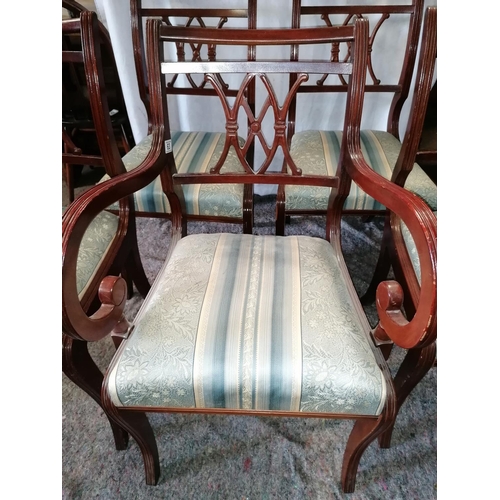 63 - A set of five reproduction dining chairs, including one carver with scroll arms, fretwork seat backs... 