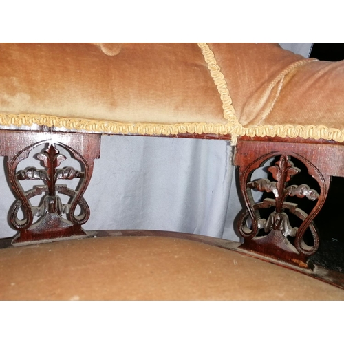 66 - A tub chair with padded arms, having turned front legs on casters, A/F - back leg damaged as picture... 