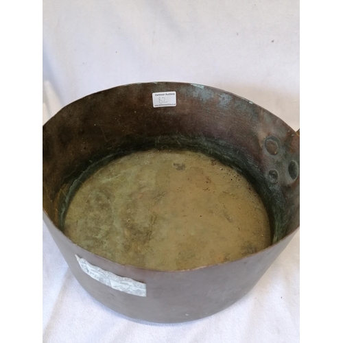 82 - A large antique copper saucepan with an iron handle, likely French, diameter 31cm