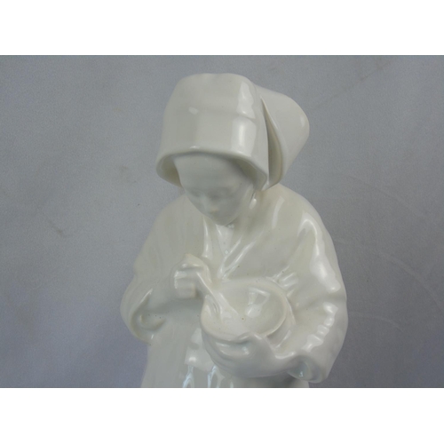 88 - A white enamel porcelain figurine of a young Breton woman eating from a bowl, made by H B Henriot of... 