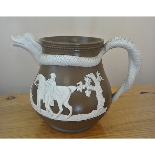 127 - A stoneware serpent jug with sprig designs to each side, in the style of Jasper ware, in very good c... 