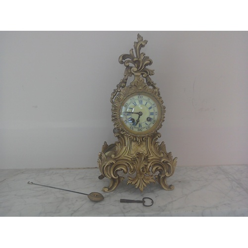 152 - A pretty ormulu mantel clock in Rococo style, H38cm, age and maker unknown, with key a/f