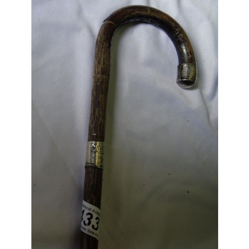 175 - An antique walking stick with silver top and band