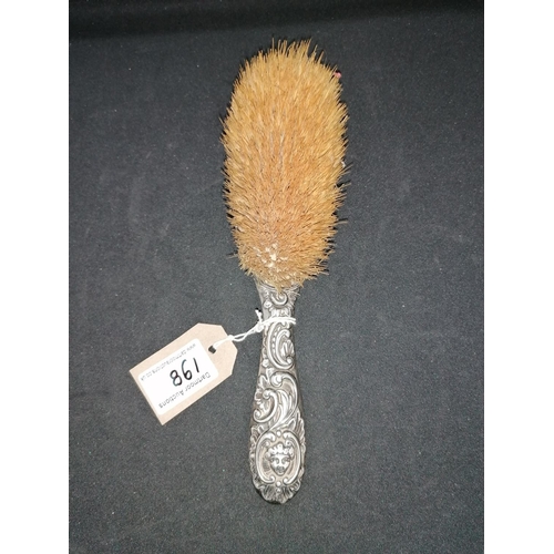 198 - A silver backed hairbrush with cherub faces