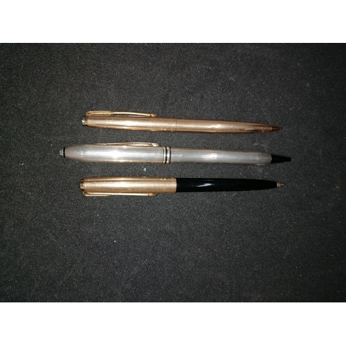 224 - Three vintage ballpoint pens: a Cross silver chrome pen (empty); two Parker pens - one black/gold, o... 