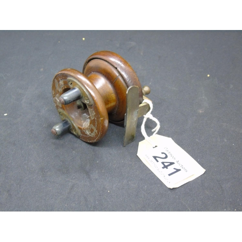 241 - A vintage fishing reel with brass fittings