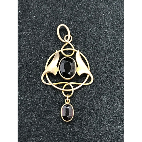 249 - A very pretty Edwardian Art Nouveau 9 carat (marked) gold pendant with two red gemstones, possibly g... 