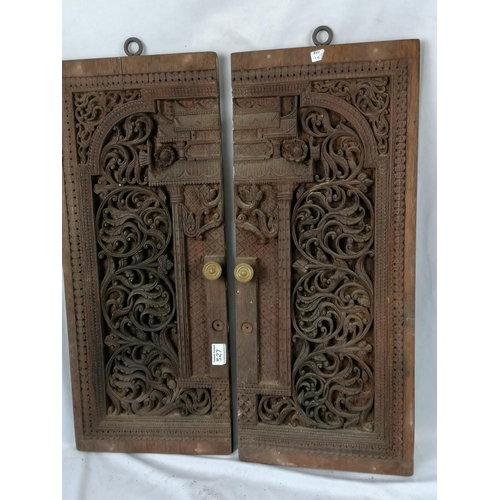 327 - A pair of carved hardwood oriental doors, H72  W (each) 30cm