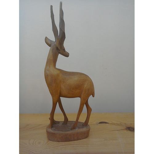 333 - A finely carved teak wood sculpture of an antelope, mid century, ht 31cm; a vintage ebony wood eleph... 