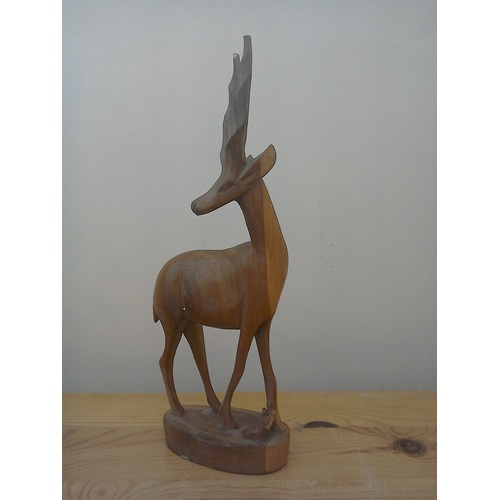 333 - A finely carved teak wood sculpture of an antelope, mid century, ht 31cm; a vintage ebony wood eleph... 