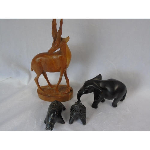 333 - A finely carved teak wood sculpture of an antelope, mid century, ht 31cm; a vintage ebony wood eleph... 