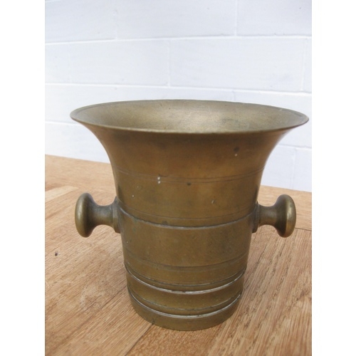 346 - A Georgian or Victorian solid brass apothecary's mortar and pestle set. The mortar is 12cm high