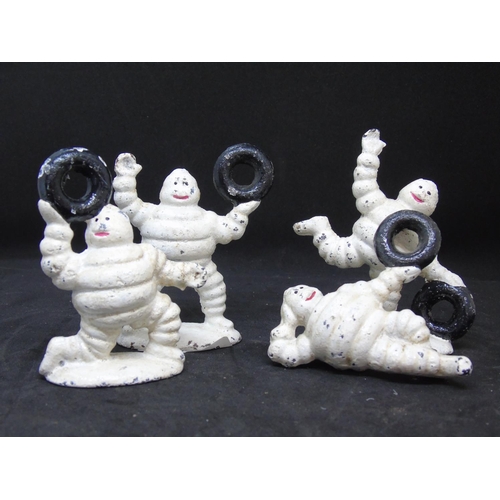 580 - Four small iron Michelin men