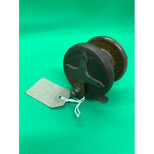 241 - A vintage fishing reel with brass fittings