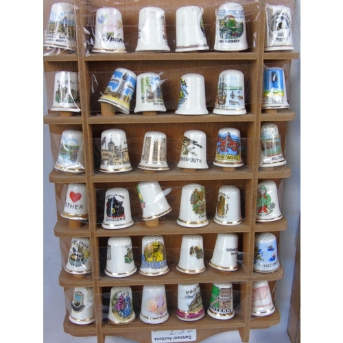 257 - A collection of 66 china collectors' thimbles in two wall racks