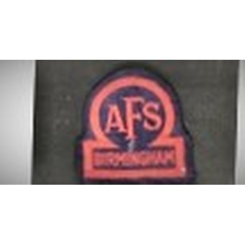 349 - An AFS Birmingham cloth badge from WW2, an AFS metal cap badge with crown, a named and numbered whit... 