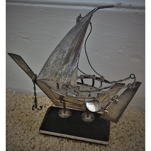 177 - A vintage white metal (low silver) model of a traditional Middle Eastern dhow, with articulated rudd... 