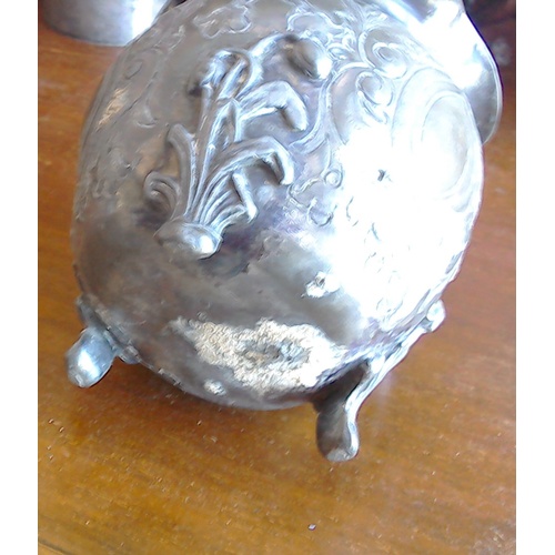 204 - A lot: an antique white metal three-legged pot with ruffled rim, relief and repousse decoration; two... 