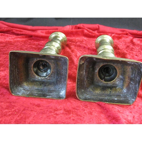 84 - A pair of brass candlesticks with balustered columns