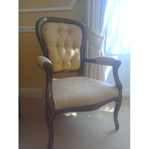 32 - A buttonback armchair upholstered in rose gold damask fabric