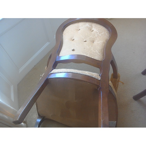 32 - A buttonback armchair upholstered in rose gold damask fabric