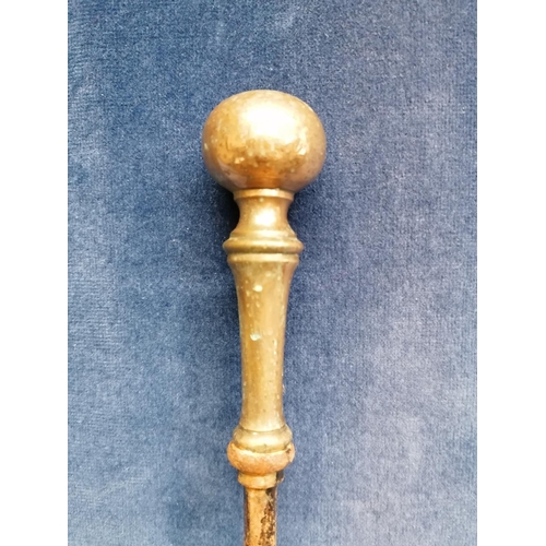 258 - An antique heavy iron fire poker with brass handle, 83cm and a long skewer with brass terminal