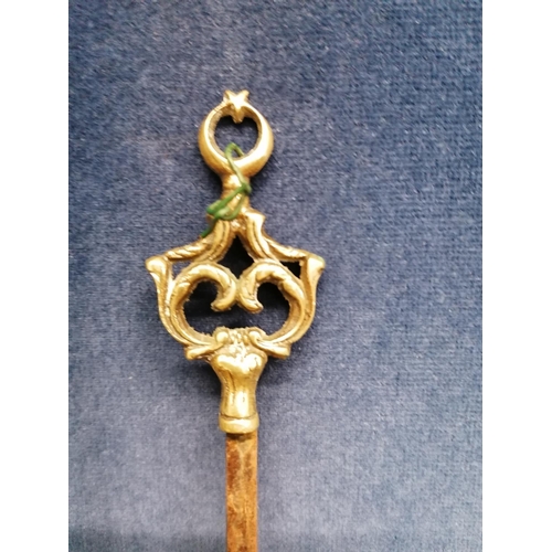 258 - An antique heavy iron fire poker with brass handle, 83cm and a long skewer with brass terminal
