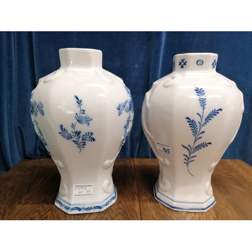 113 - Two Delft blue baluster-shaped chimney vases one decorated with a mill race,the other a river landsc... 