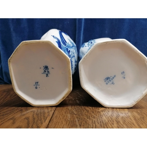113 - Two Delft blue baluster-shaped chimney vases one decorated with a mill race,the other a river landsc... 