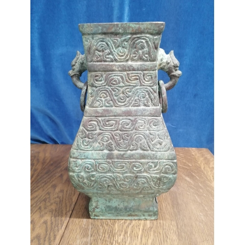 115 - A heavy bronze Chinese archaic style pear-shaped vase, the sides cast with scrolls and the upper fla... 