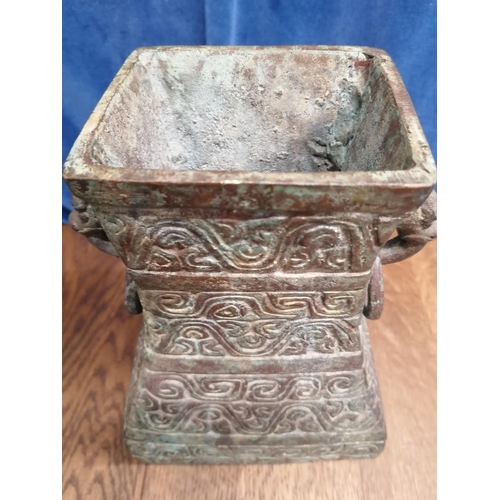115 - A heavy bronze Chinese archaic style pear-shaped vase, the sides cast with scrolls and the upper fla... 