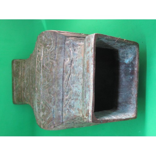 115 - A heavy bronze Chinese archaic style pear-shaped vase, the sides cast with scrolls and the upper fla... 