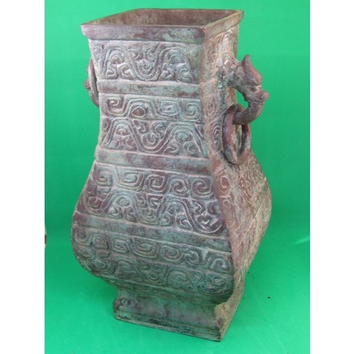 115 - A heavy bronze Chinese archaic style pear-shaped vase, the sides cast with scrolls and the upper fla... 