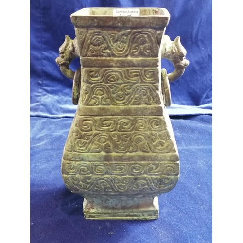 115 - A heavy bronze Chinese archaic style pear-shaped vase, the sides cast with scrolls and the upper fla... 