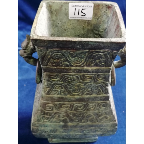 115 - A heavy bronze Chinese archaic style pear-shaped vase, the sides cast with scrolls and the upper fla... 
