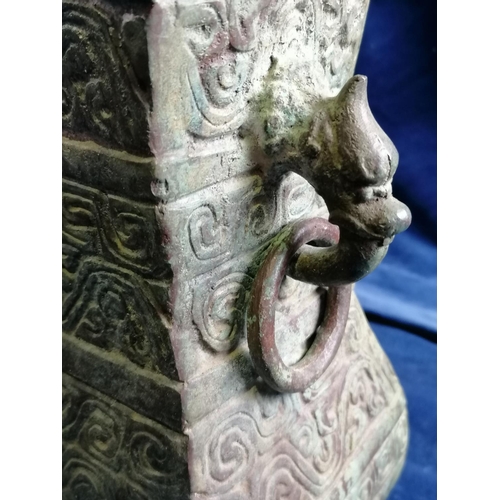 115 - A heavy bronze Chinese archaic style pear-shaped vase, the sides cast with scrolls and the upper fla... 