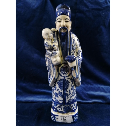 116 - A Chinese blue and white figure of an Immortal  holding a child, 31cm high
