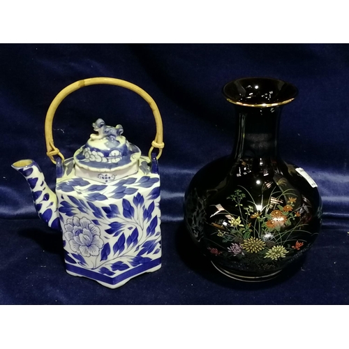 247 - A blue/white Oriental teapot with bamboo handle,the cover with a dog foe; also a Japanese chimney va... 