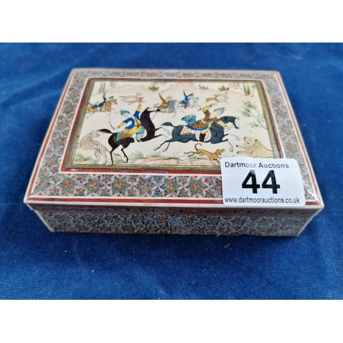 44 - A papier mache Oriental box containing an abacus; also a Persian cigarette box with hunting scene, c... 