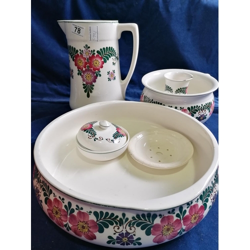 78 - A Continental five-piece washstand set, brightly painted with stylised flowers on a white ground