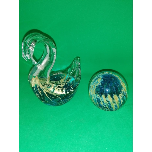 94 - A Mdina glass model of a swan bears remnants of paper label 12 cm high and a spherical paperweight