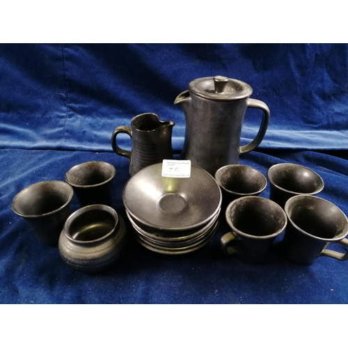 70 - A Prinknash six setting coffee service, each with dark gunmetal lustre glaze