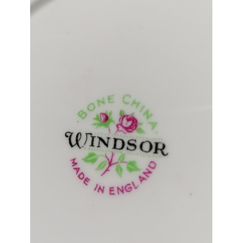 77 - A decorative Windsor tea service, the circular outlines, profusely gilded with flowers, conforming d... 